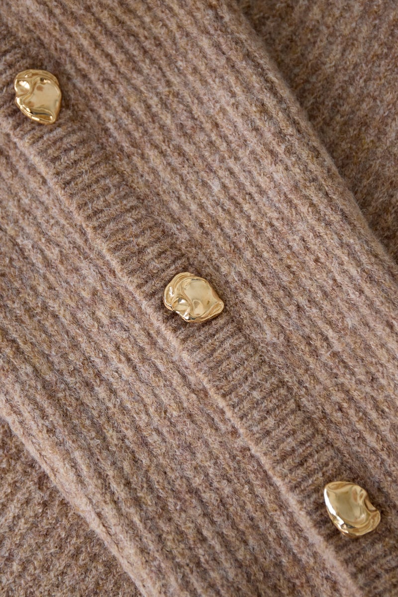 Sweater with buttons on the sleeves